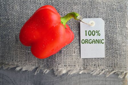 Red organic bell pepper on sacking napkin background.Organic vegetables, healthy food, raw diet or vegan food concept.Selective focus.の写真素材