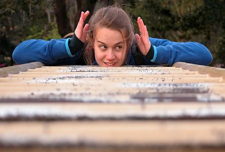 Girl on bars with head held between handsの写真素材