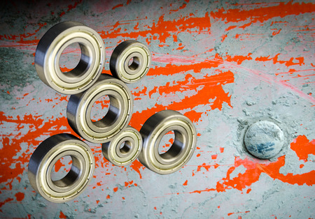 Metal Bearings on a Grunge background with reflection. Composition with bearings. Mechanisms,...