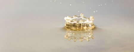 Photo Collection of drops falling into water.Splashes of water. Water drops. Frozen droplets on a colored background.の写真素材