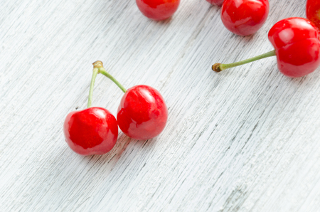 Cherries on a white background. Red berries with green twigs.の写真素材