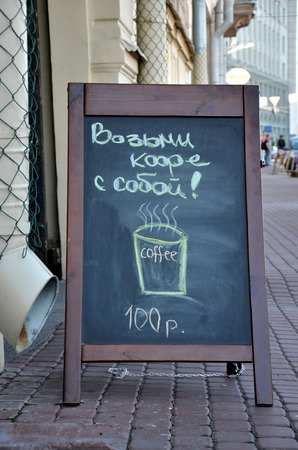 Take coffee away with you! Offer on the blackboard written in chalkの写真素材