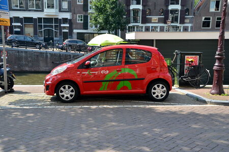 Electric vehicle of company Green wheels on the quay in Amsterdam, Hollandのeditorial素材