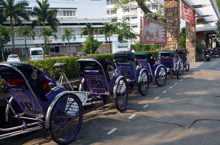 Cityscape of Hue Vietnam. Raw of cycle rickshaw in one of the central streetsのeditorial素材