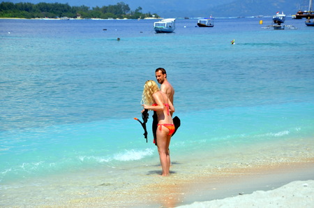 ouple with snorkeling equipment enters the sea. Gili Trawangan, Indonesiaのeditorial素材