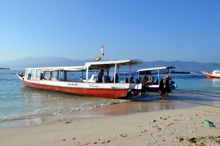 Gili Trawangan, Indonesia. Men unload a boatのeditorial素材