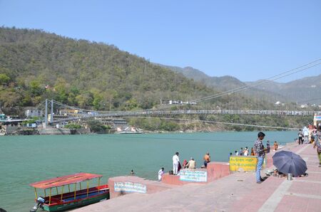 View on the Ganga river and Ram Jhula bridge in holy Indian city Rishikeshのeditorial素材