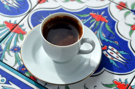 A cup of turkish coffee on a background of oriental tileの写真素材