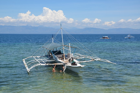 Young couple at bangka boat in the ocean in Moalboal, Philippines, Cebu Islandのeditorial素材