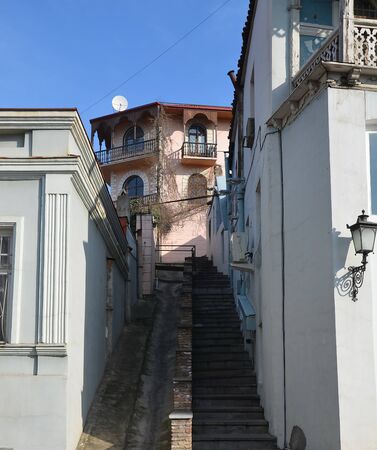 A small steep street with stairs in the old town of Tbilisi, Georgiaの写真素材