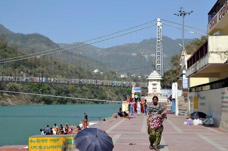 RISHIKESH, INDIA - APRIL 7, 2013 - View on the Ganga river and Ram Jhula bridge in holy Indian city...