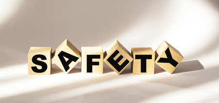 safety word written on wood block. safety text on wooden table for your desing, concept.の写真素材