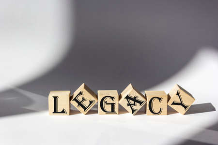 Word LEGACY made from wooden building blocks on white backgroundの写真素材