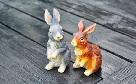 Ceramic bunny toys on a wooden floor