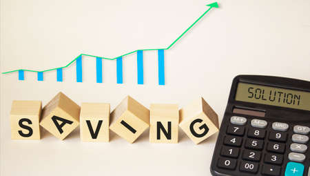 On a white background wooden cubes with the text save, graph and calculator with the text decisionの写真素材