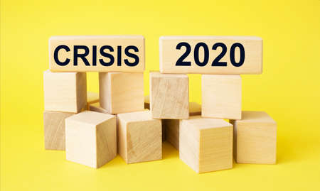Crisis 2020, yellow background is written on wooden blocksの写真素材