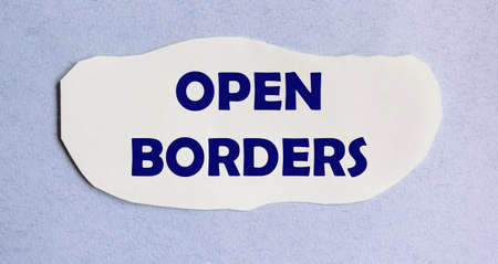 Opened borders, text on white paper and blue background