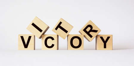 Victory, text on wooden cubes on light backgroundの写真素材