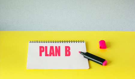 Plan B note with pen on yellow backgroundの写真素材