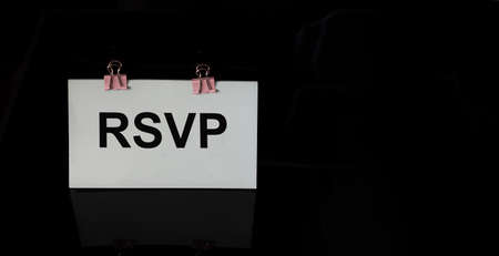RSVP word written on white sticker and black backgroundの写真素材