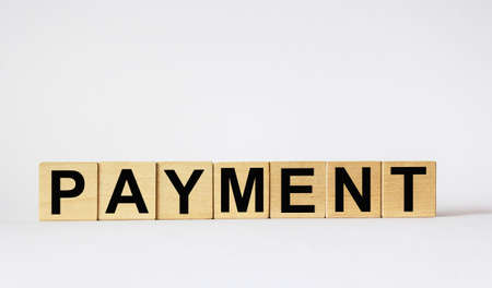 Wooden blocks with the text: PAYMENT. Text written in black letters against a white background. New concept of starting a new business.の写真素材