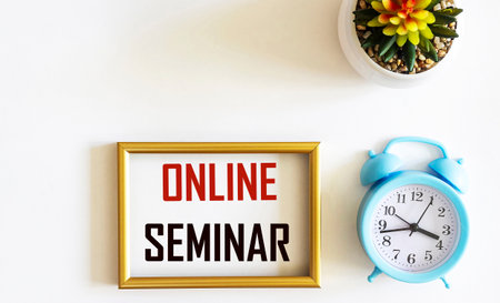In a photo frame with the text Online Seminar, isolated on white with alarm clock and cactus.の写真素材