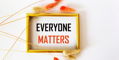 The phrase Everything Matters written in red ink on a photo frame and white background in a vintage frame with ears of wheatの写真素材