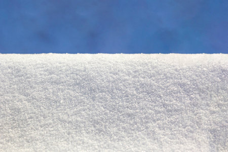 In clear sunny weather, clean snow background against the blue sky