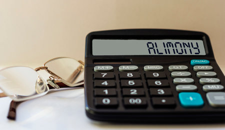 Calculator with the word alimony on the displayの写真素材