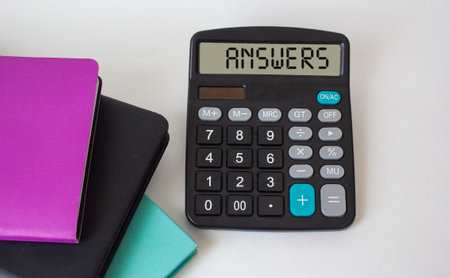 Business concept. The word Answers, written on the display of the calculator and on a white background, lie next to multi-colored notepads.の写真素材