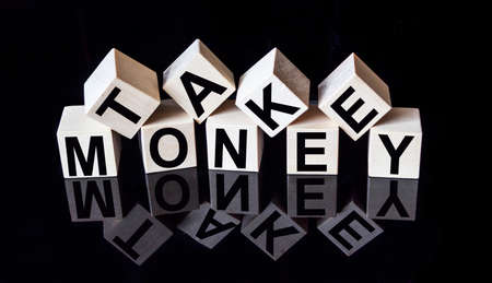 On a black mirrored background with reflection cubes with the text TAKE MONEYの写真素材