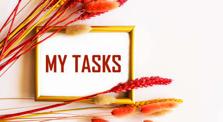 The text My tasks on a gold frame and a white background framed by colored ears of wheat