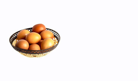 Basket of colored eggs on a white backgroundの写真素材