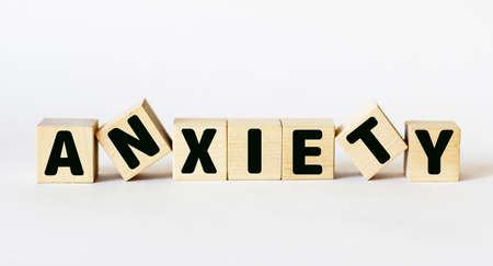the word of ANXIETY on a wooden cubes