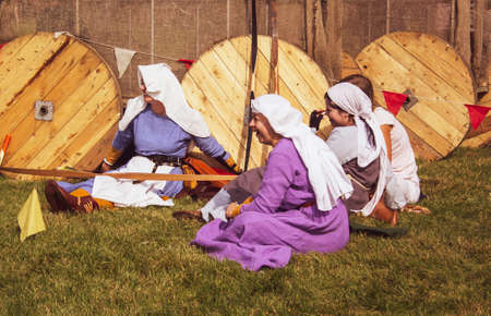 Archer girls are sitting on the grass, resting. City holiday on September 8, 2018, Minsk. Belarusのeditorial素材