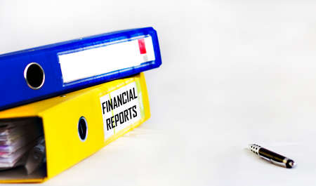 A folder for documents with the inscription on it Financial report, on a white background with a...
