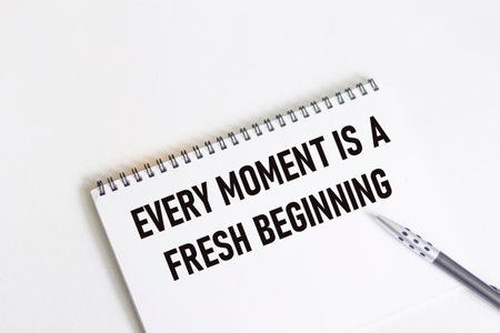 Every moment is a new beginning. Inspirational quote on notepad with pen.の写真素材