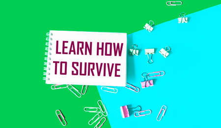 Text on Notepad Learn How to Survive. Survival in times of crisis business concept. Survival during...