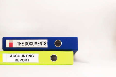 Business and finance concept. On a white table there are two folders with the text DOCUMENTS and ACCOUNTING REPORTの写真素材