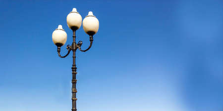 Three round white lanterns against a clear blue sky.の写真素材