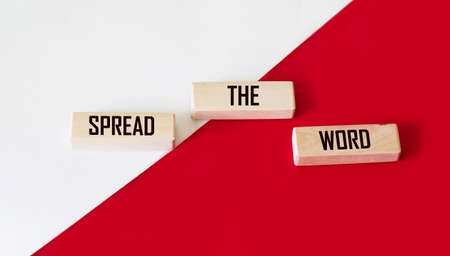 Spread the word word written on wood block. Spread the word text on table, concept.の写真素材