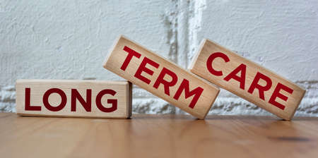 Word LONG TERM CARE on wooden blocks and beautiful backgroundの写真素材
