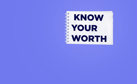 Text Know your worth in notepad on purple background. business conceptの写真素材