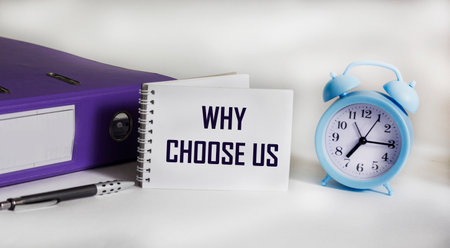 Text on notepad Why choose us Question. Business concept for a list of advantages and disadvantages for product selection.の写真素材