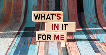 WHAT'S IN IT FOR ME text on wooden blocks and vintage background