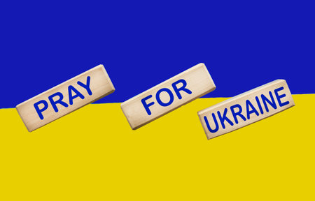 War between Ukraine and Russia. The flag of Ukraine and the symbol of victory. Freedom and text Pray for Ukraine. Military conflict in Ukraineの写真素材
