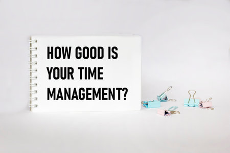 Text HOW GOOD IS YOUR TIME MANAGEMENT written on a notepad and white backgroundの写真素材