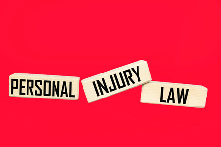 Personal Injury Law text made from wooden blocks on red background