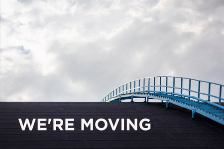On a black background with the text WE ARE MOVING. business conceptの写真素材