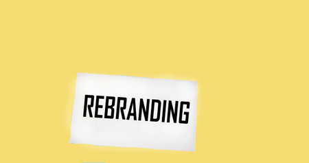 The text REBRANDING appearing behind torn brown paperの写真素材